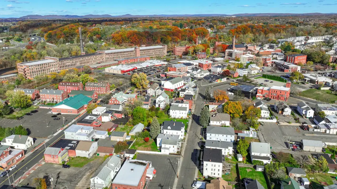 Aerial view of red-brick mills and downtown blocks in autumn foliage, Chicopee, Massachusetts