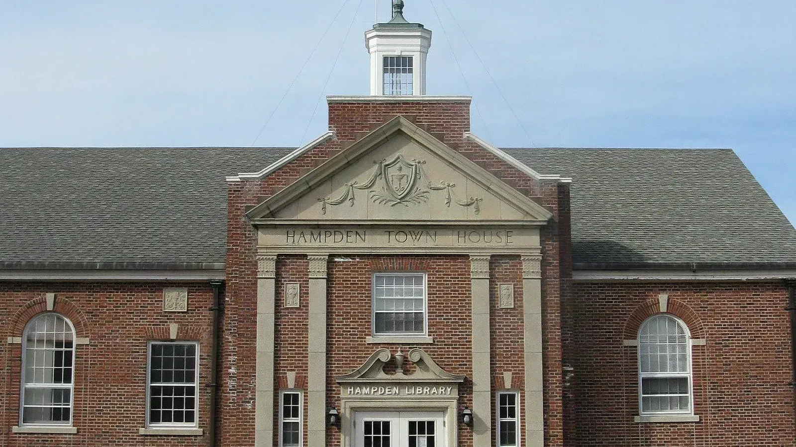Brick Colonial Revival Hampden Town House and public library beneath a white cupola, Hampden, Massachusetts