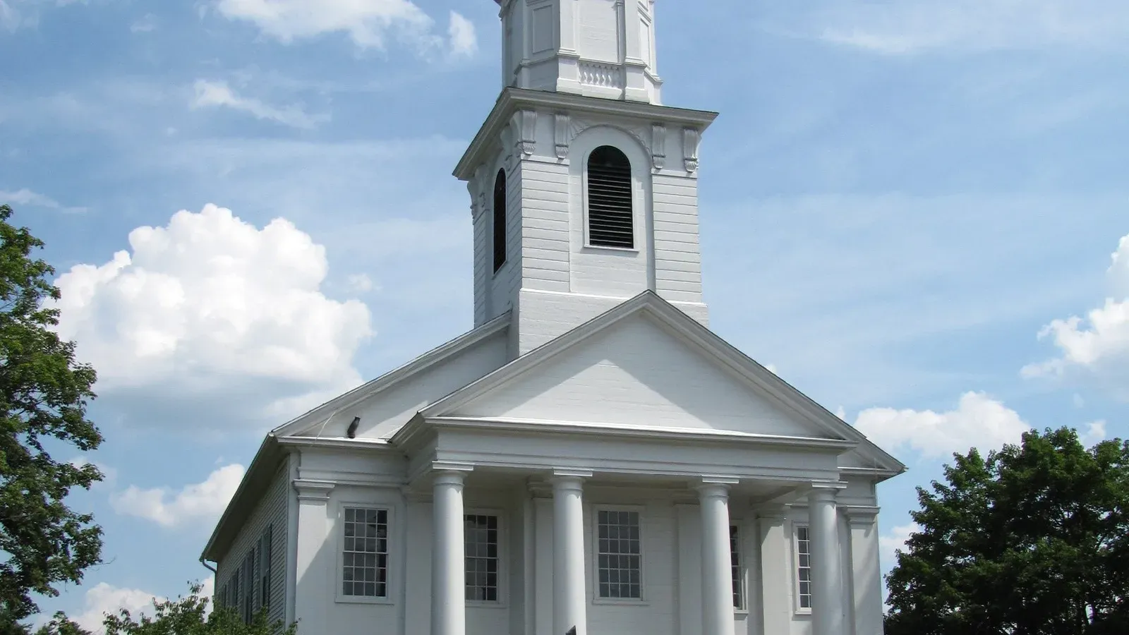 White Greek Revival Congregational church with a columned portico and steeple, Southwick, Massachusetts