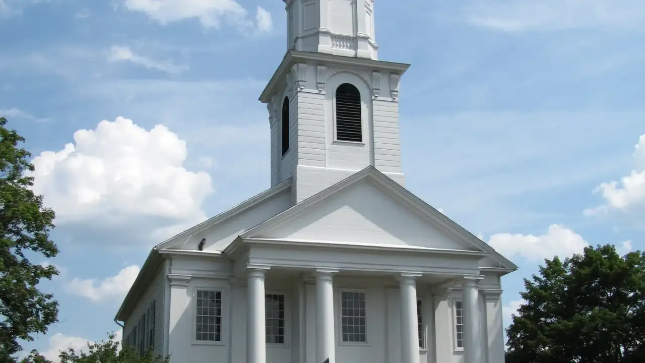 White Greek Revival Congregational church with a columned portico and steeple, Southwick, Massachusetts