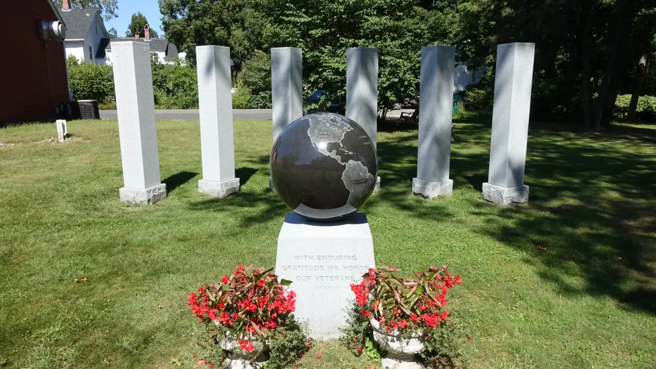 Granite veterans memorial with an engraved globe and honor-roll pillars, Wilbraham, Massachusetts